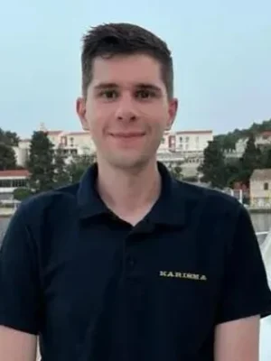 Marin Petranović, rotational chef on yacht Karisma, wearing a dark polo shirt with the yacht logo