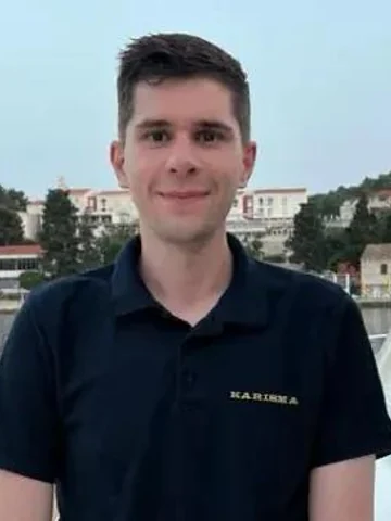Marin Petranović, rotational chef on yacht Karisma, wearing a dark polo shirt with the yacht logo